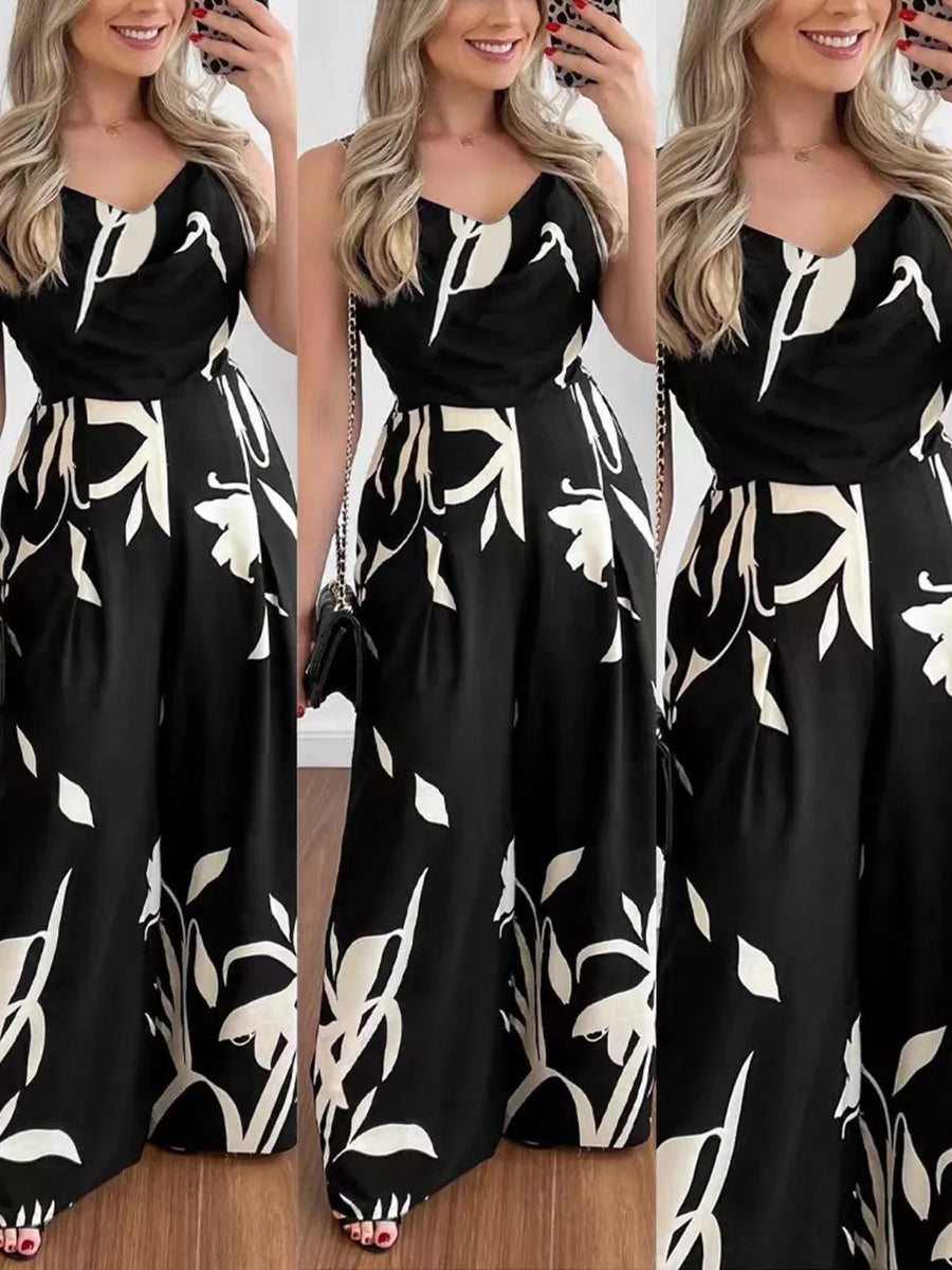 Black abstract leaf print wide-leg jumpsuit with cinched waist and adjustable straps.
