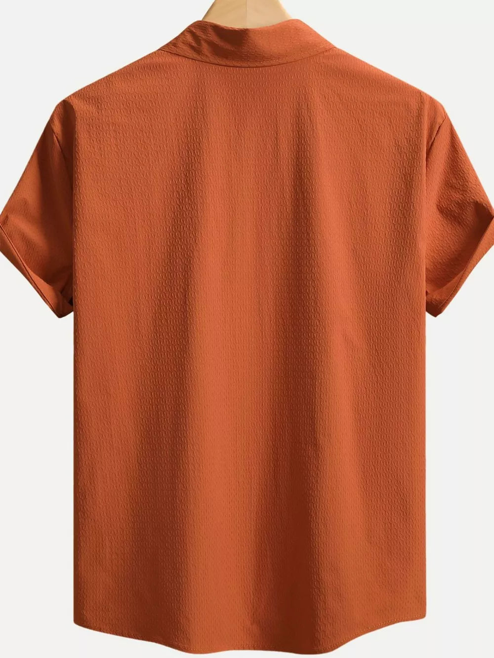 Orange textured cotton Cuban collar casual shirt with short sleeves.