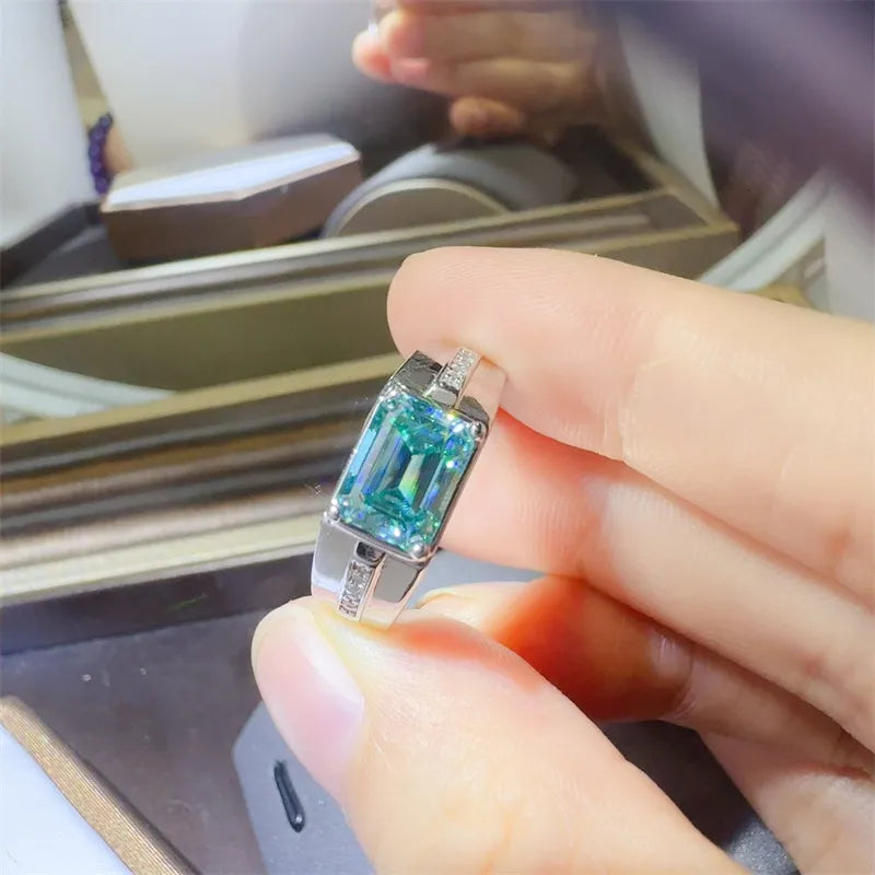 Silver ring with emerald cut moissanite and accent stones, architectural design