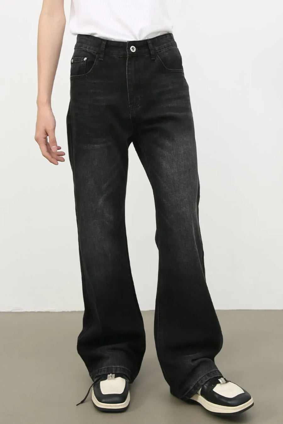 Dark wash denim trousers with exaggerated flare, 70s style