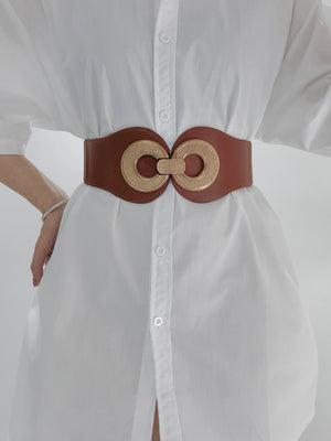 Caramel elastic belt with gold double circle metalwork clasp cinching a white shirt