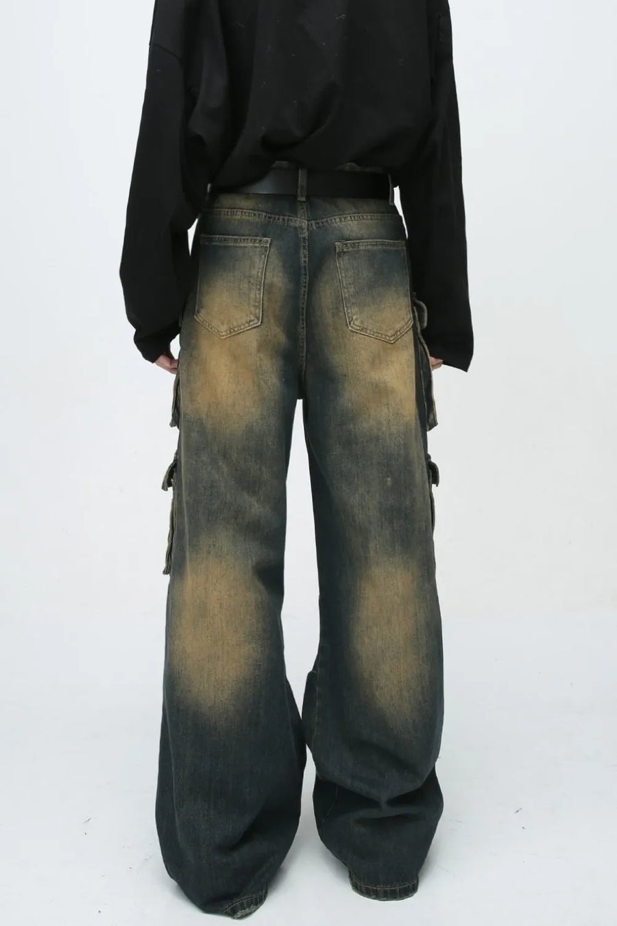 Faded wash dark denim oversized cargo jeans with button flap pockets and baggy fit.
