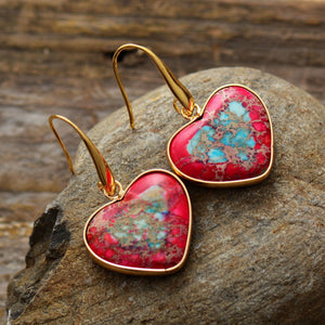 Heart-shaped jasper and gold earrings with red and blue stone details.