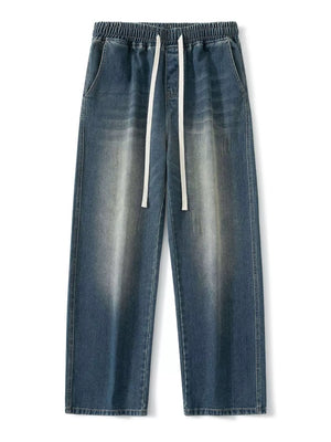 Vintage wash wide-leg jeans in light blue with elastic waistband and drawstring.