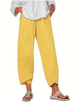 Yellow relaxed fit wide-leg pants with pockets and asymmetrical hem detail.