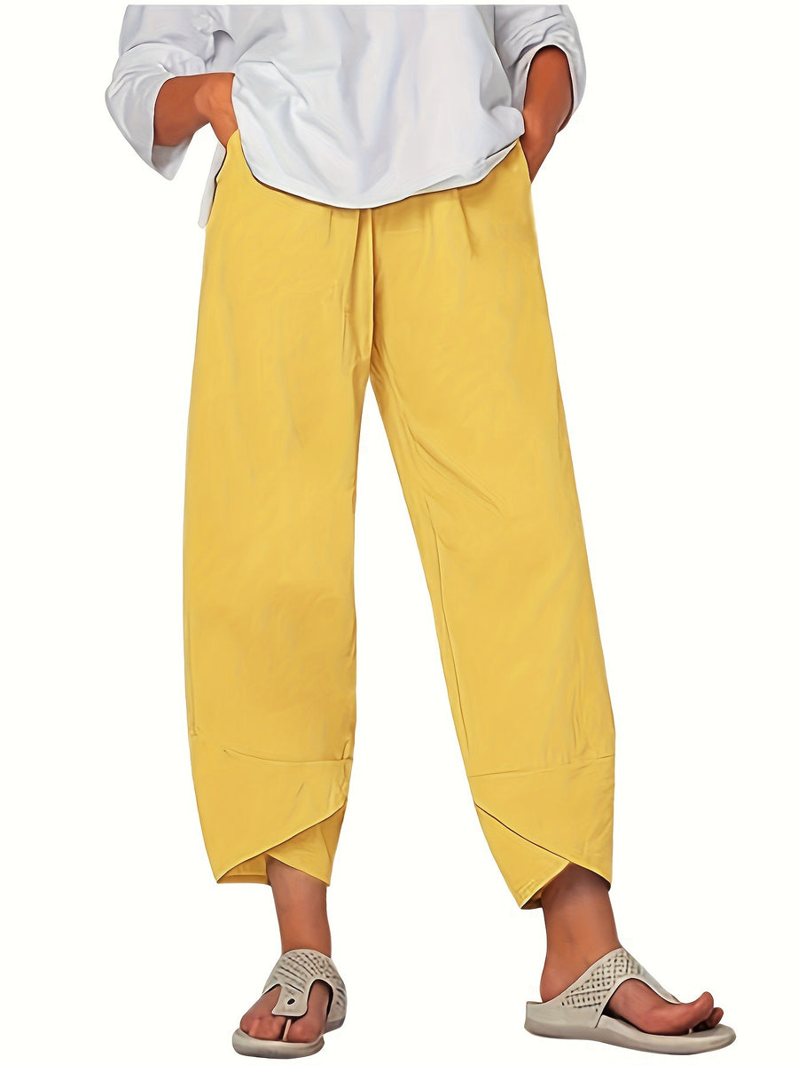 Yellow relaxed fit wide-leg pants with pockets and asymmetrical hem detail.
