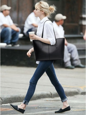 tote in black featuring top handles and boxy fit