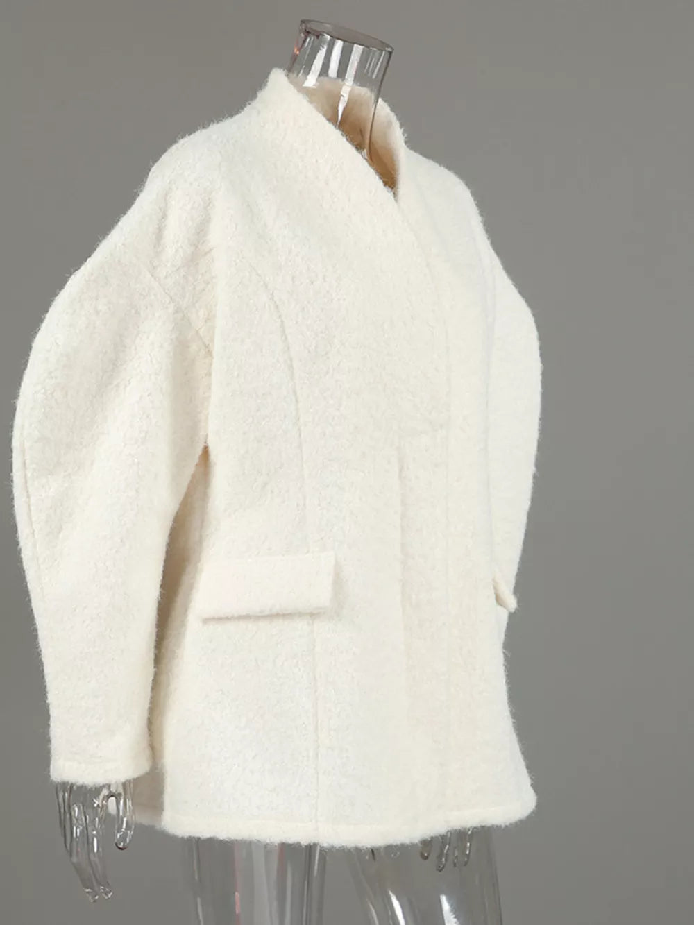 coat in cream with pocketed and hip-length