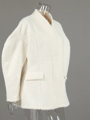coat in cream with pocketed and hip-length