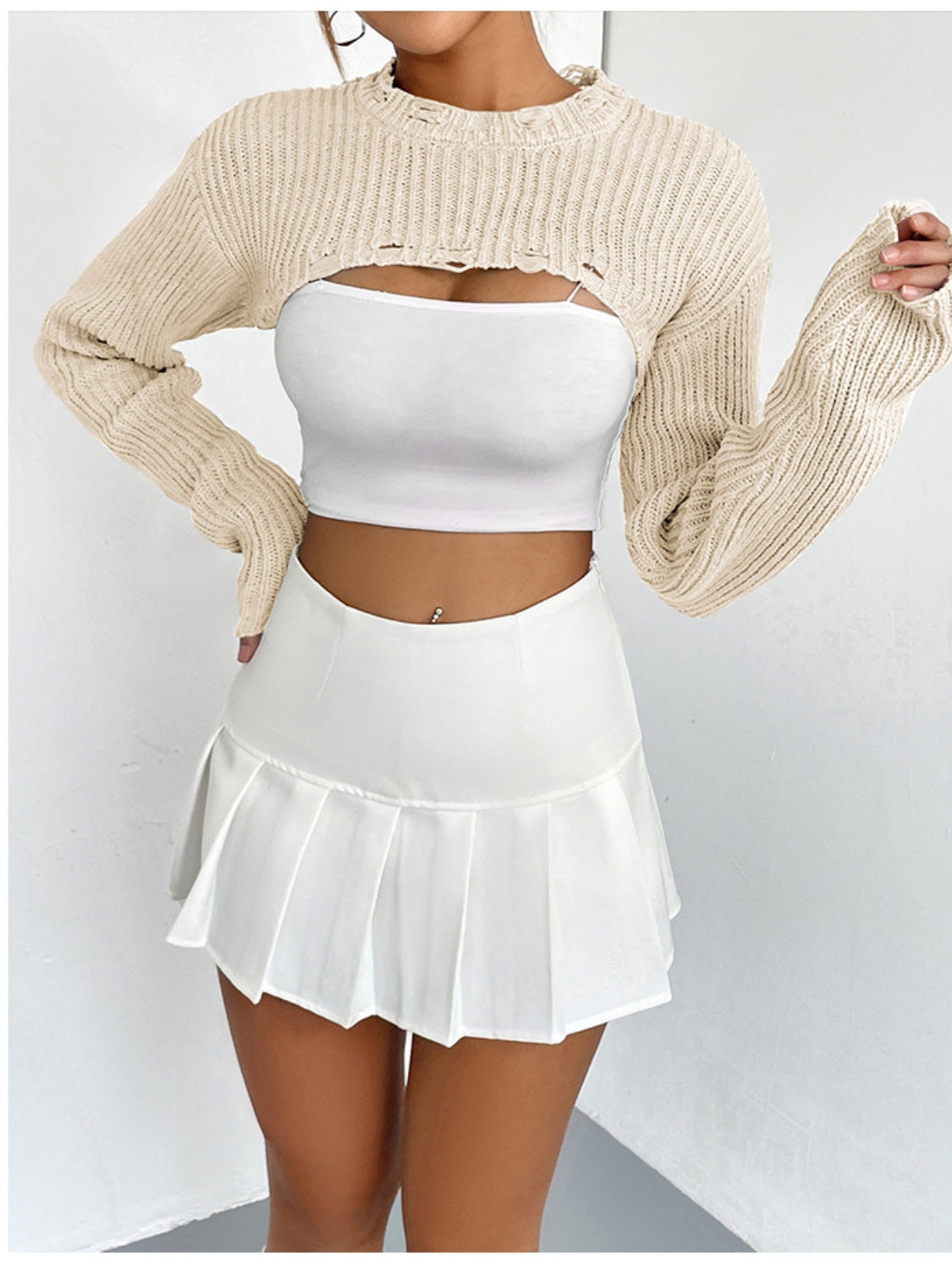 Cream distressed knit bolero crop top with ripped details and long sleeves.