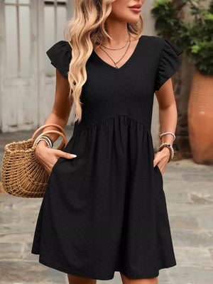 Black a-line dress with ruffled sleeves, v-neck, and textured fabric.