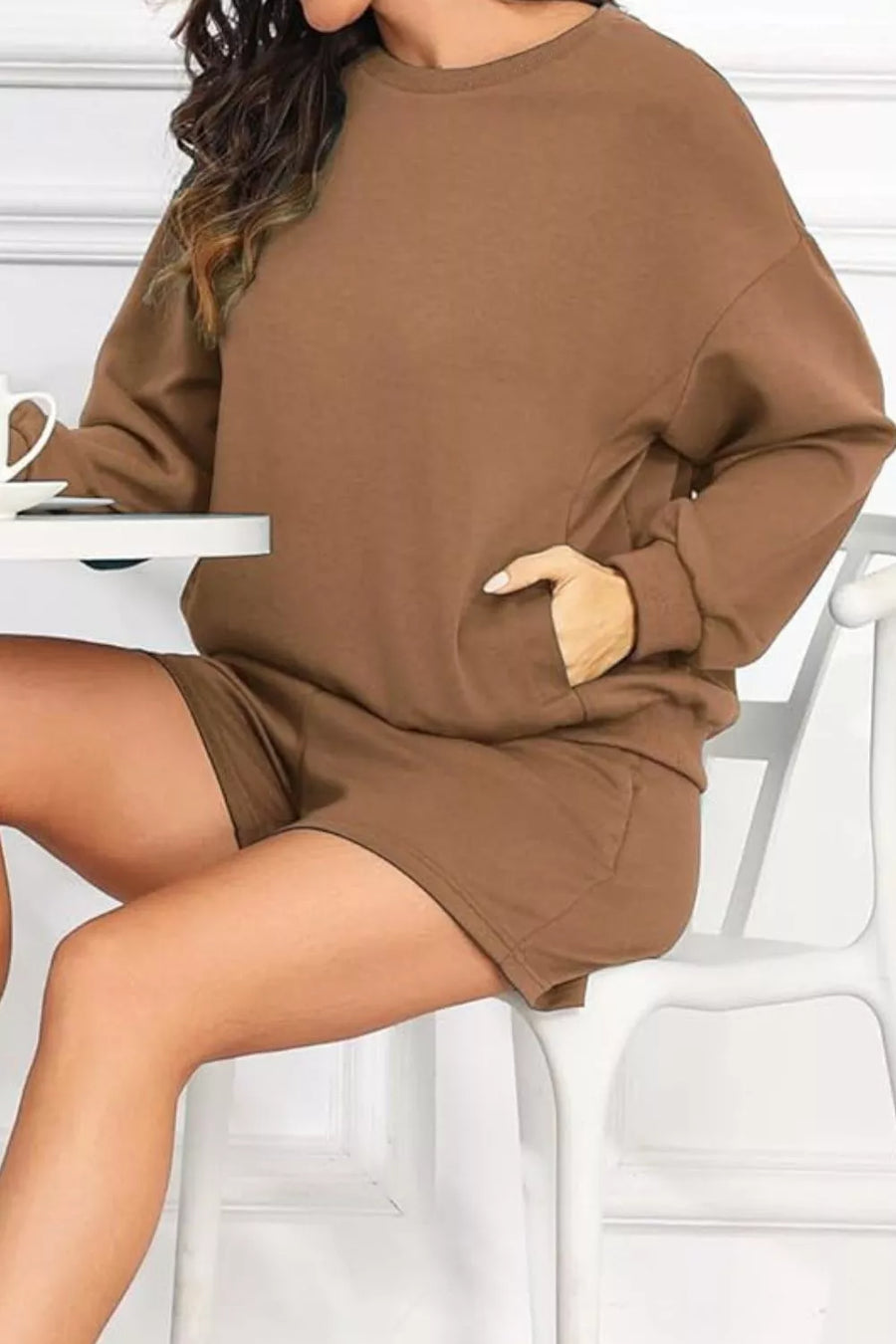 Cozy two-piece sweatshirt set in caramel with crew neck, long sleeves, and shorts with pockets.