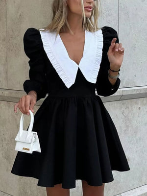 Black puff sleeve dress with white ruffled collar and flared skirt