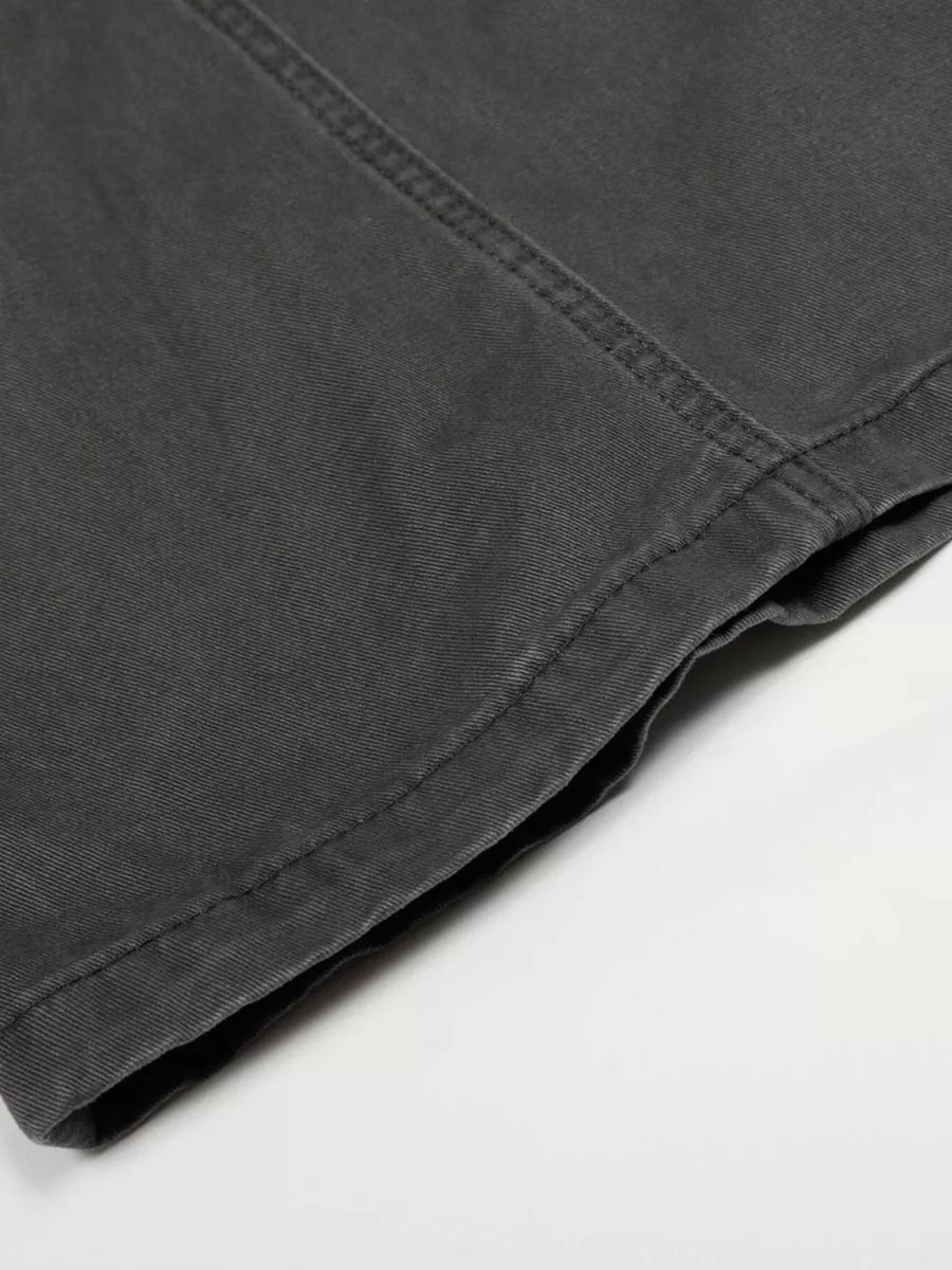Grey relaxed fit cargo pants detail showing stitching and hem.