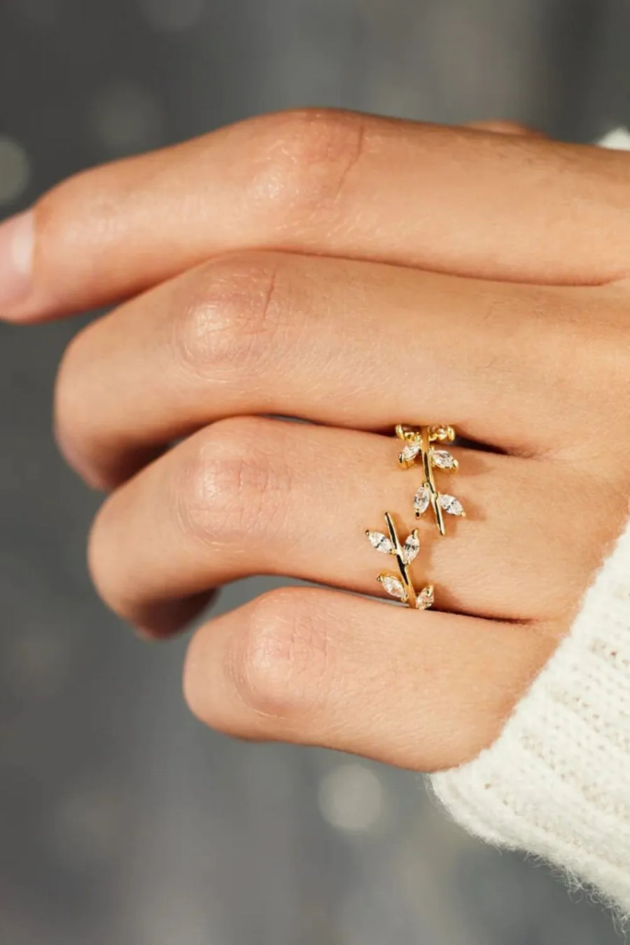 Gold branching foliage open ring with cubic zirconia accents.
