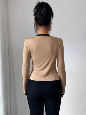 Khaki long sleeve top with black trim detail, part of a two-piece set.