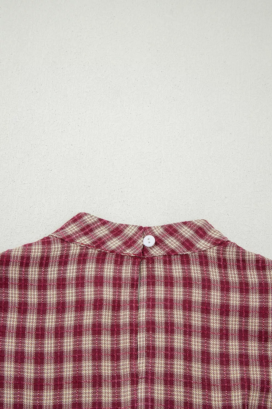 Burgundy plaid long sleeve blouse with button keyhole detail at back neck.