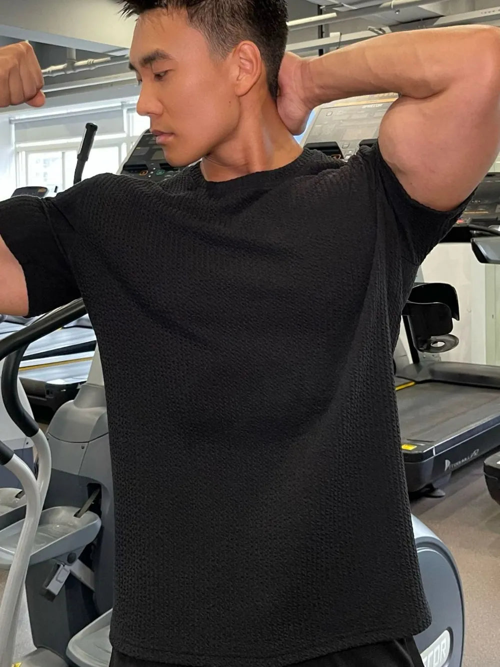 Black textured performance crew neck tee with short sleeves.