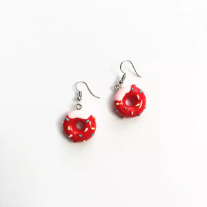 Red donut dangle earrings with pink icing and colorful sprinkles.