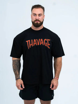 Black oversized graphic tee with orange "THAVAGE" print, short sleeves, crew neck.