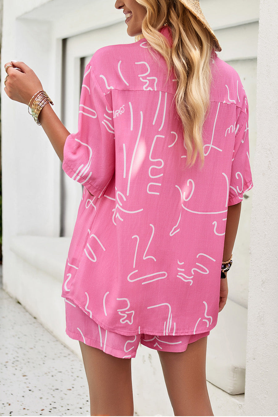 Pink abstract print resort shirt with button-down collar and short sleeves, paired with matching shorts.