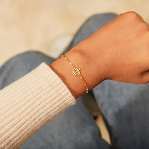 Gold beaded bracelet with crown charm and colorful enamel beads