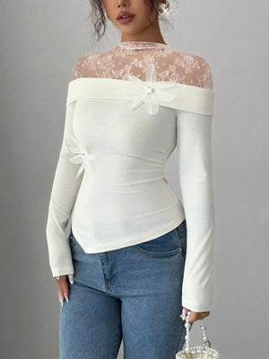 White lace detail long-sleeve bodysuit with off-shoulder neckline and floral embellishments.