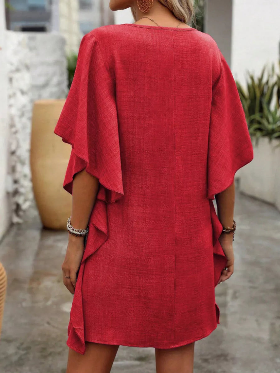 Red mini dress with V-neck, flowy flutter sleeves, and ruffled hem detail.
