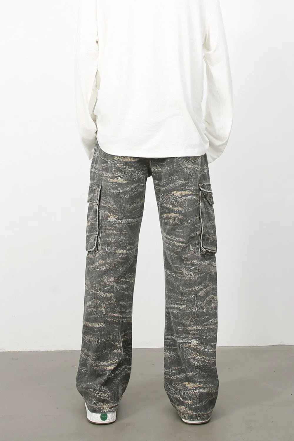 Distressed camo wide-leg cargo jeans in dark gray with utility pockets.
