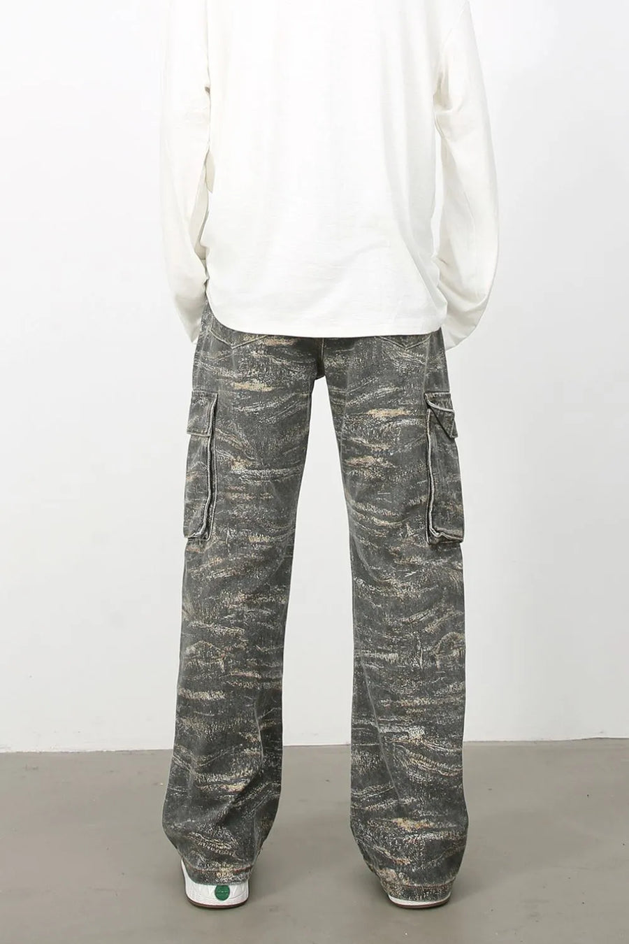 Distressed camo wide-leg cargo jeans in dark gray with utility pockets.