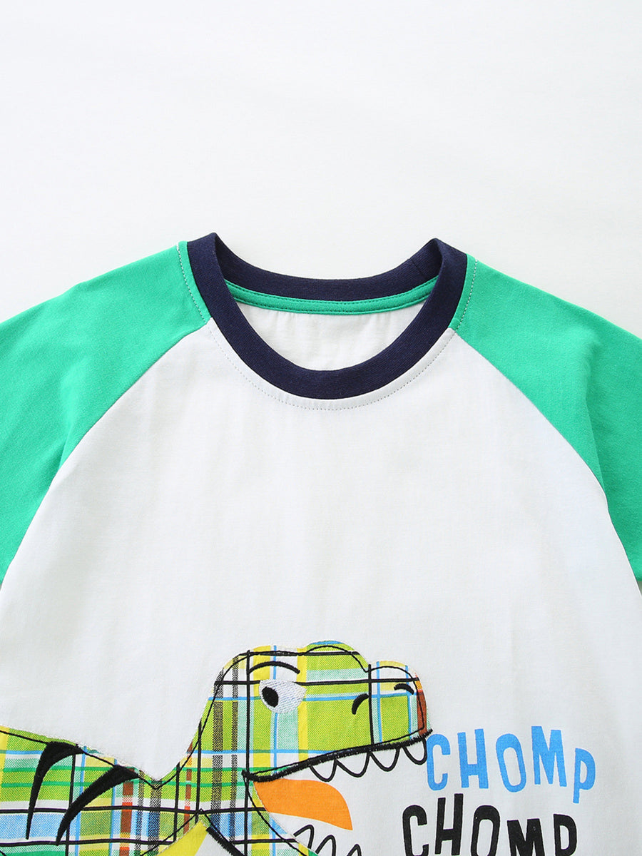 Baby t-shirt with green raglan sleeves, crew neck, and a plaid dinosaur graphic with "CHOMP CHOMP" text.