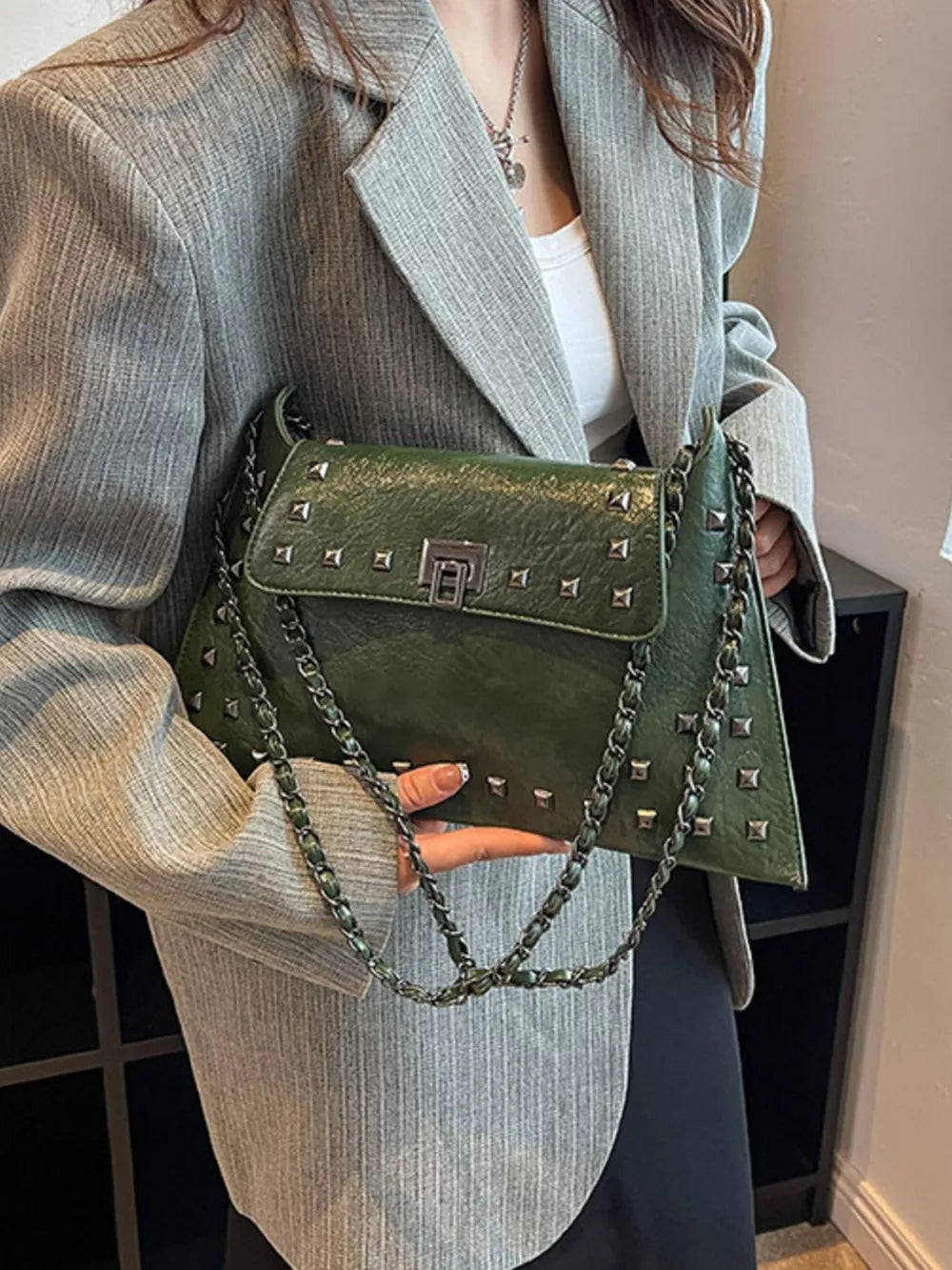 Green embellished chain flap shoulder bag with silver studs and clasp.