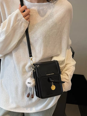Black pu leather mini crossbody bag with charm and fluffy keychain