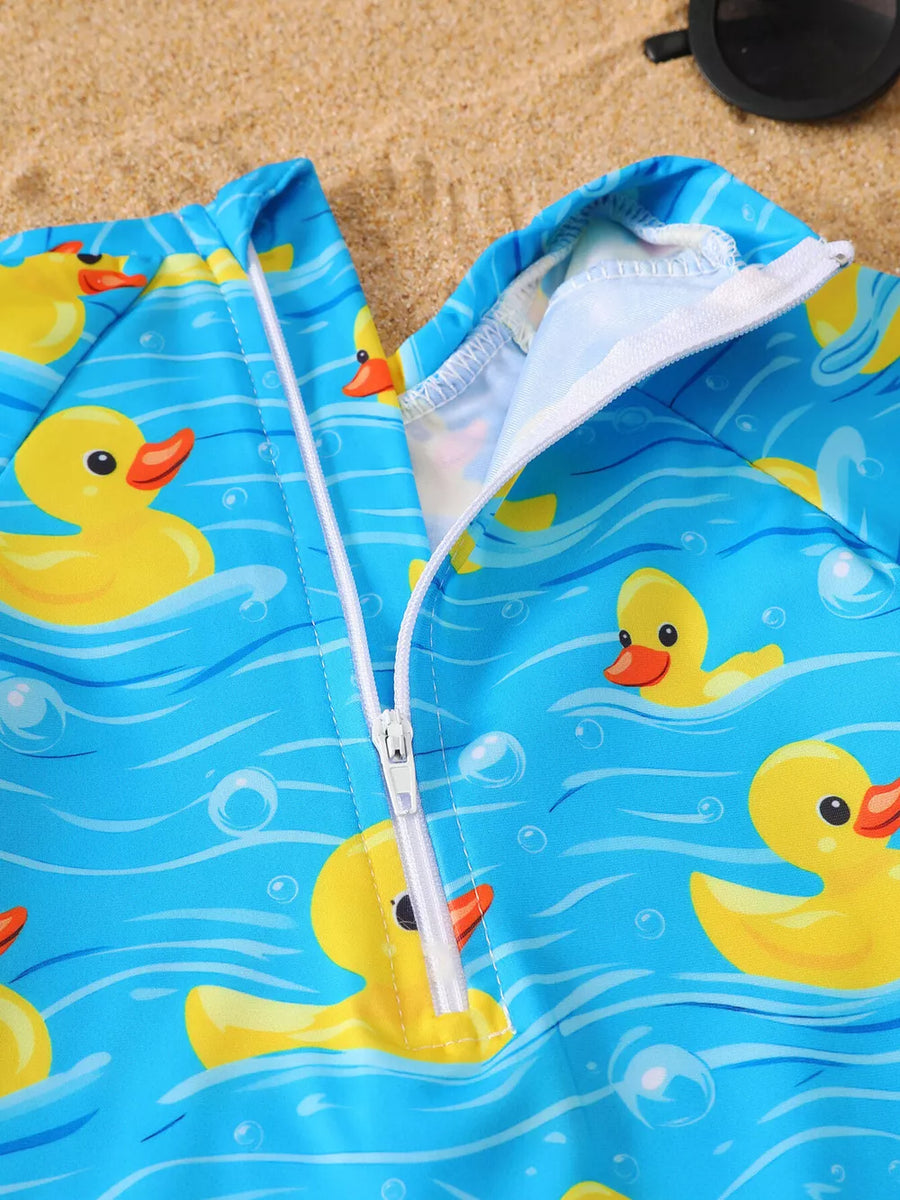 Baby one-piece swimsuit with yellow duck print on blue water pattern, zip front.