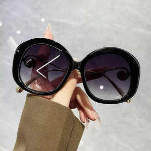 sunglasses in black featuring UV400 protection and oversized fit