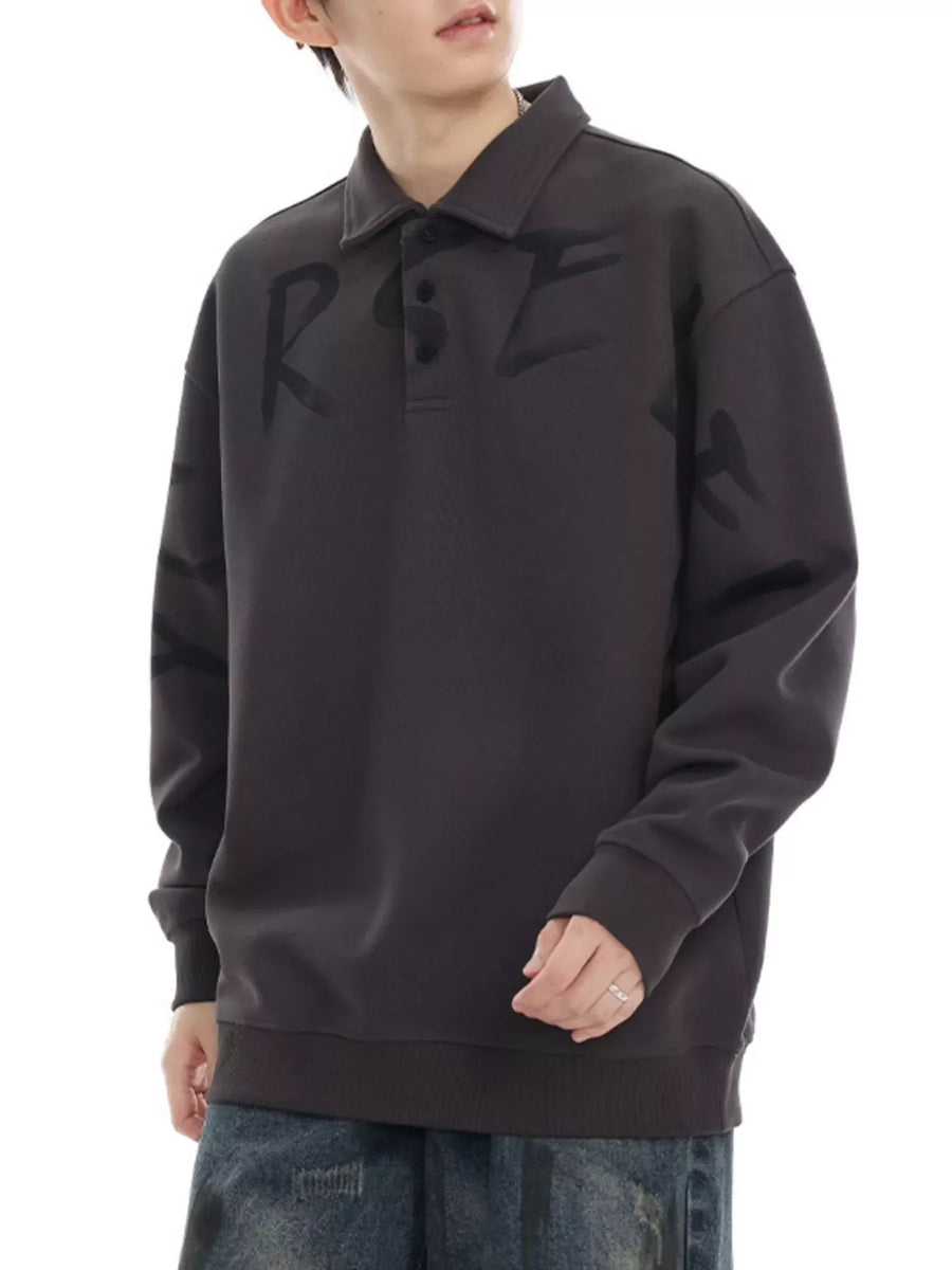 Oversized dark gray polo sweatshirt with black graphic letter print and button placket.