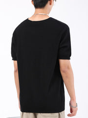 Black knit t-shirt with short sleeves and a crew neck.