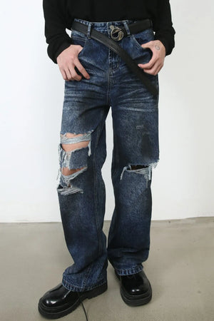 Dark wash denim jeans with distressed rips and a relaxed fit.