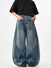 Blue acid-wash wide-leg jeans with white stripes and baggy fit.
