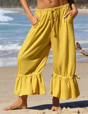 wide-leg pants in mustard yellow featuring tied and wide-leg fit