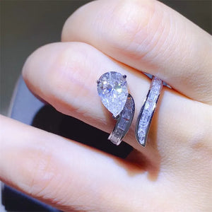 Silver bypass ring with pear cut diamond and baguette accents