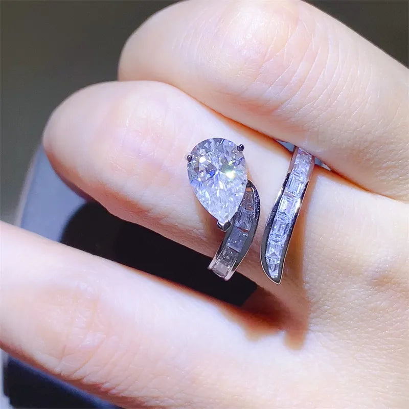 Silver bypass ring with pear cut diamond and baguette accents