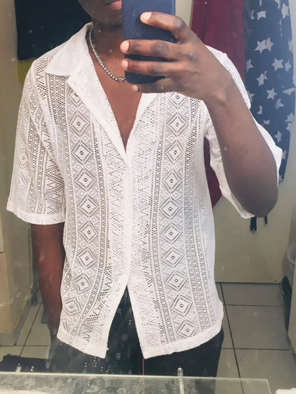 White crochet button-up shirt with geometric pattern and short sleeves.