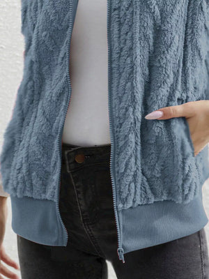 Blue faux fur zip-up vest with ribbed hem and pockets