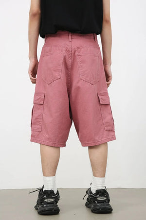 Magenta baggy cargo bermuda shorts with textured fabric and multiple pockets.