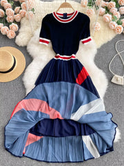 Navy midi dress with pleated color block skirt and striped trim