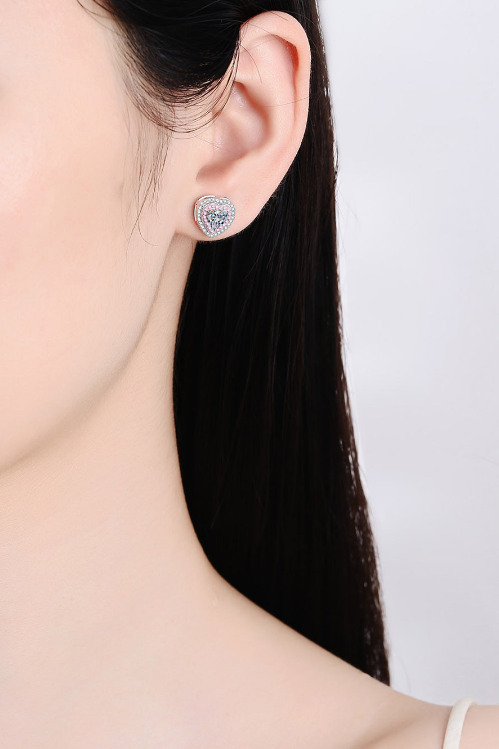 Silver heart halo stud earrings with pink accents and clear cubic zirconia.