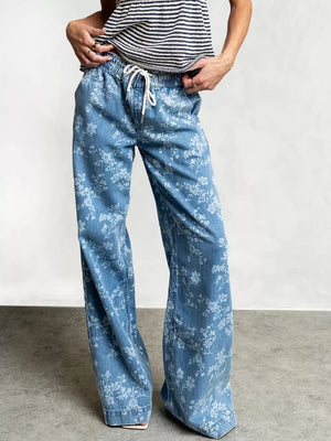 white wide-leg jeans featuring drawstring waist and floral