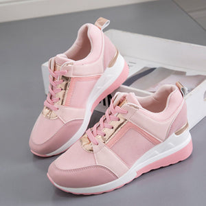Pink lace-up wedge sneakers with metallic accents and white soles.