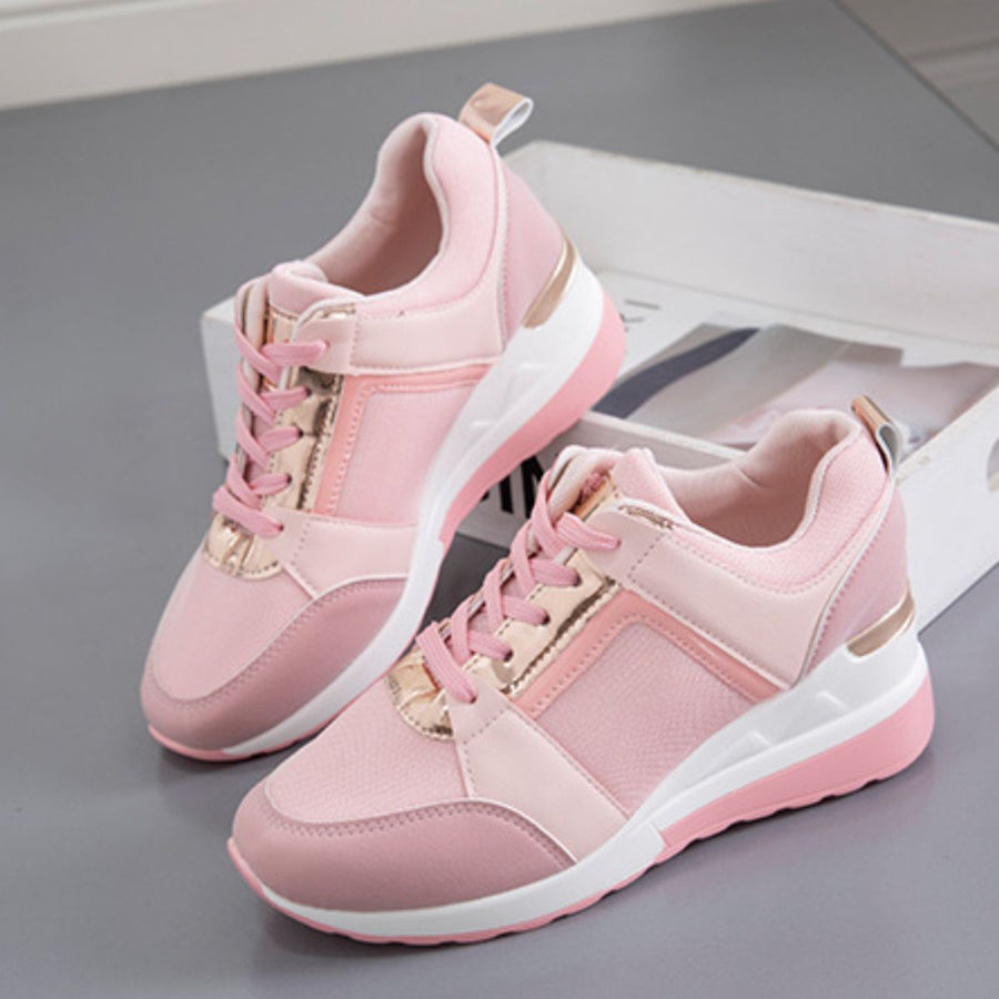 Pink lace-up wedge sneakers with metallic accents and white soles.